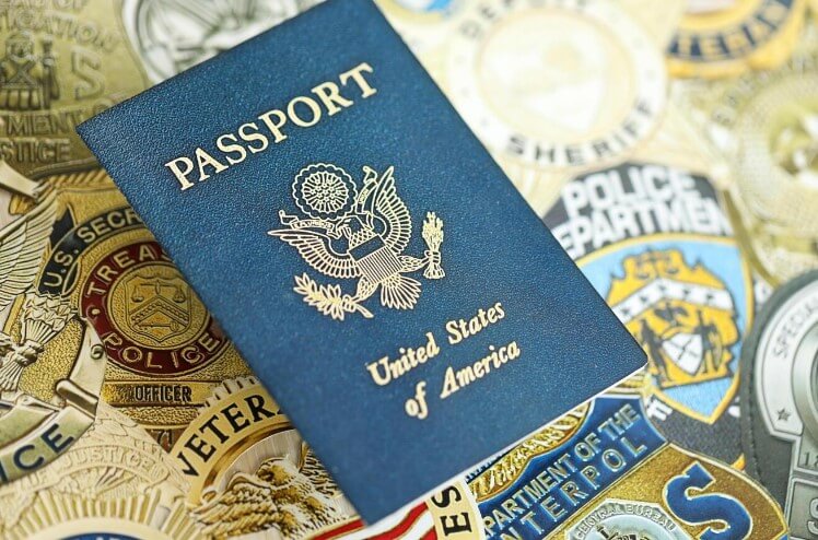 A picture of US passport with a background of US army and US police department logos.